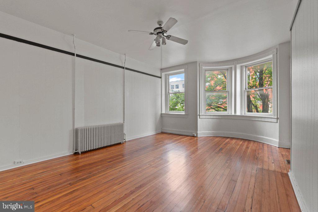 217 East Preston Street Baltimore, MD 21202 - Photo 14 of 60 a view of an empty room with a window and wooden floor