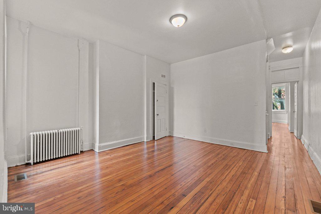 217 East Preston Street Baltimore, MD 21202 - Photo 16 of 60 an empty room with wooden floor and windows