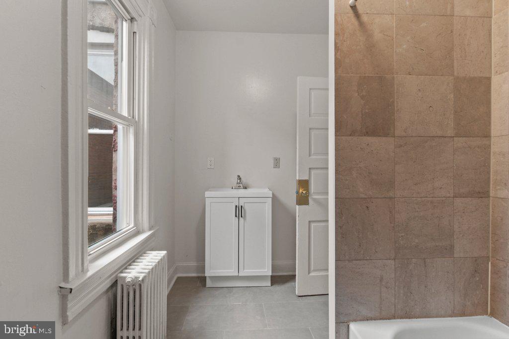 217 East Preston Street Baltimore, MD 21202 - Photo 21 of 60 a bathroom with a shower and a sink