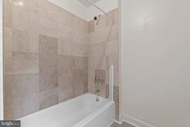 a view of a livingroom with wooden floor and staircase