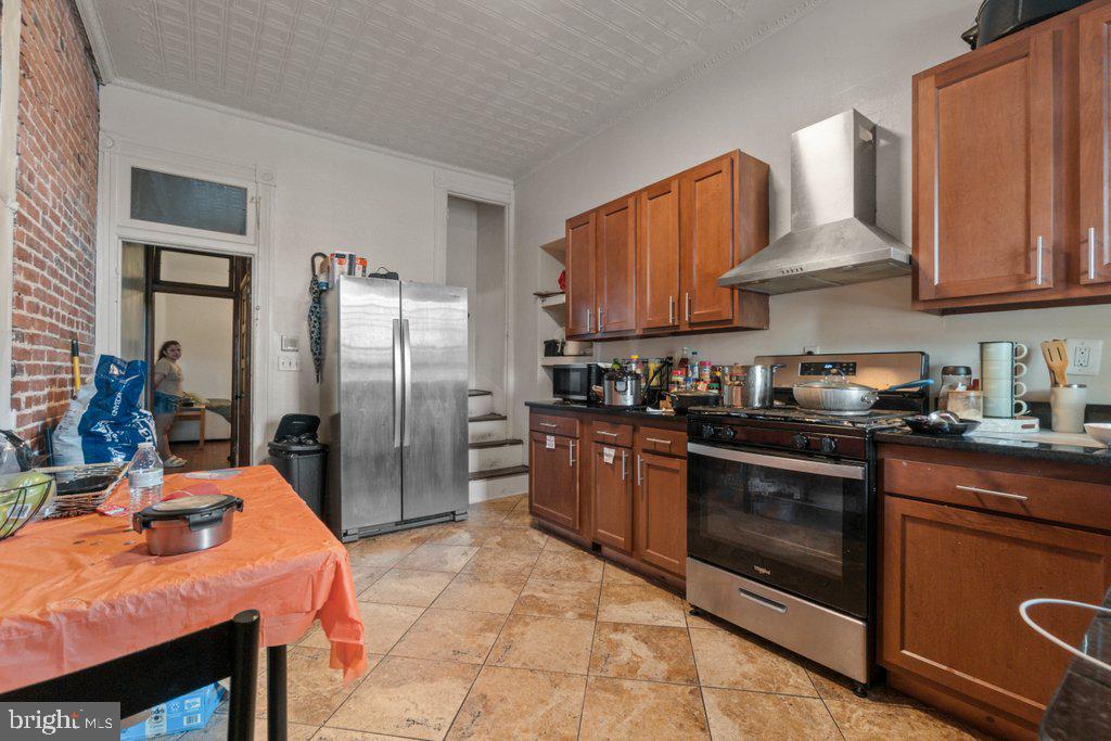 217 East Preston Street Baltimore, MD 21202 - Photo 30 of 60 a kitchen with stainless steel appliances granite countertop a refrigerator a sink a stove and island