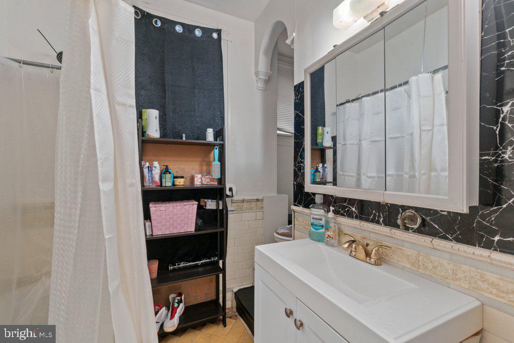 217 East Preston Street Baltimore, MD 21202 - Photo 37 of 60 a bathroom with a sink and a mirror