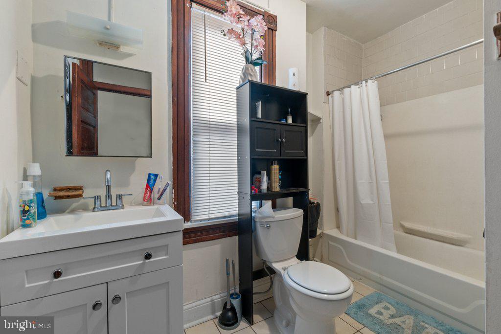 217 East Preston Street Baltimore, MD 21202 - Photo 40 of 60 a bathroom with a sink a toilet and a mirror