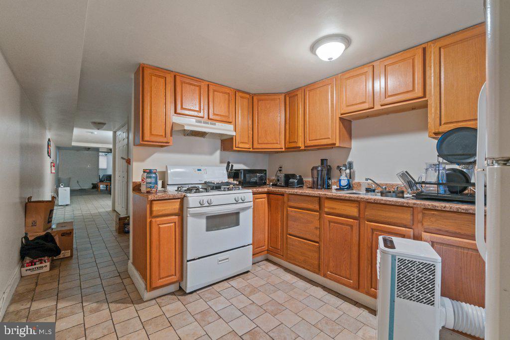 217 East Preston Street Baltimore, MD 21202 - Photo 41 of 60 a kitchen with stainless steel appliances granite countertop a stove a sink and a refrigerator