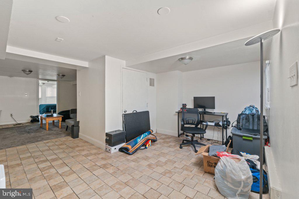 217 East Preston Street Baltimore, MD 21202 - Photo 43 of 60 a view of a workspace with furniture and a window