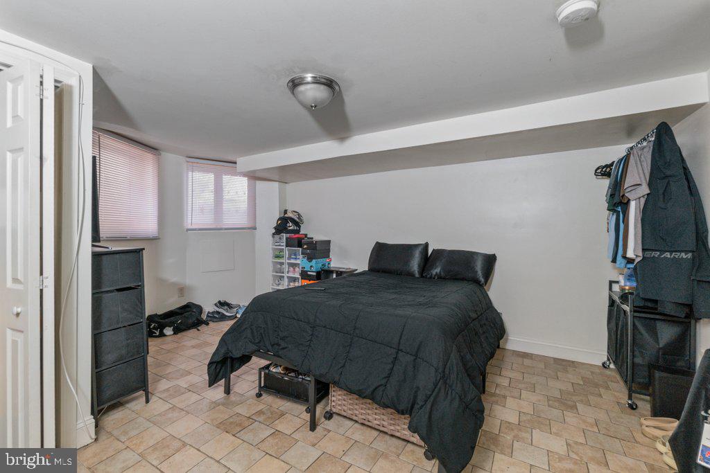 217 East Preston Street Baltimore, MD 21202 - Photo 45 of 60 a bedroom with a bed and a tv on the wall