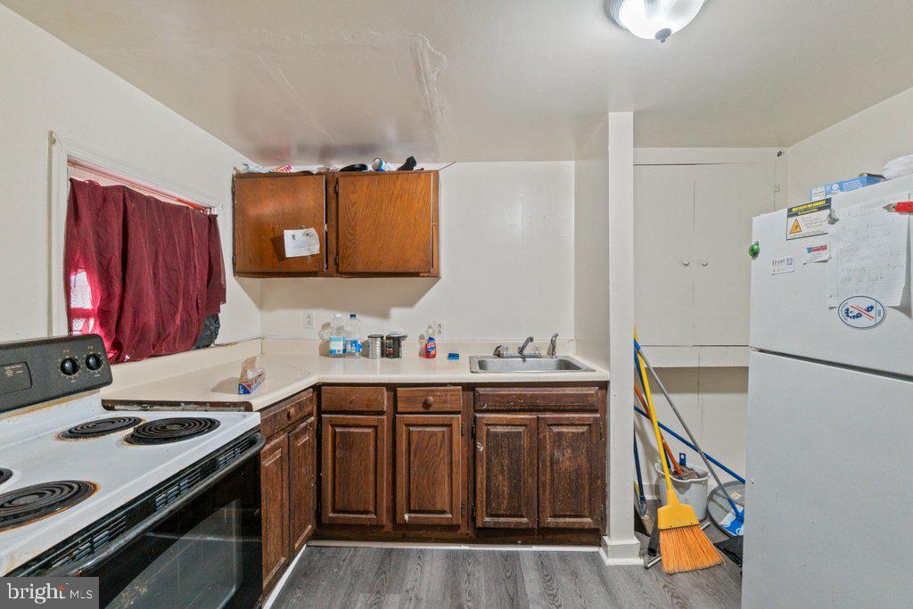 217 East Preston Street Baltimore, MD 21202 - Photo 49 of 60 a kitchen with a sink stove and refrigerator