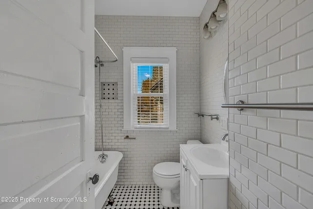 a bathroom with a toilet a sink a shower and bathtub