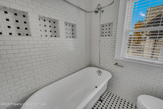 a bathroom with a bathtub and shower