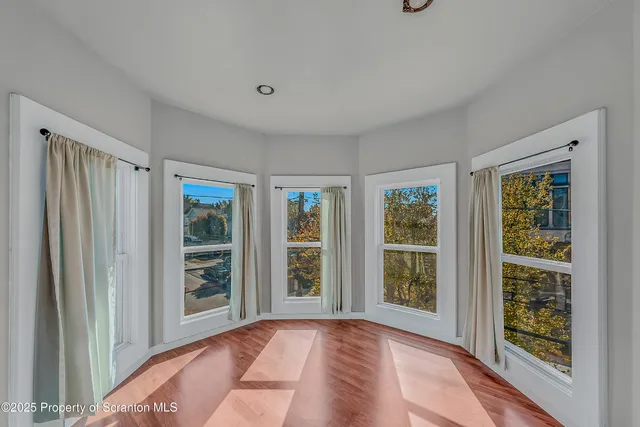 a view of an empty room with glass door and balcony
