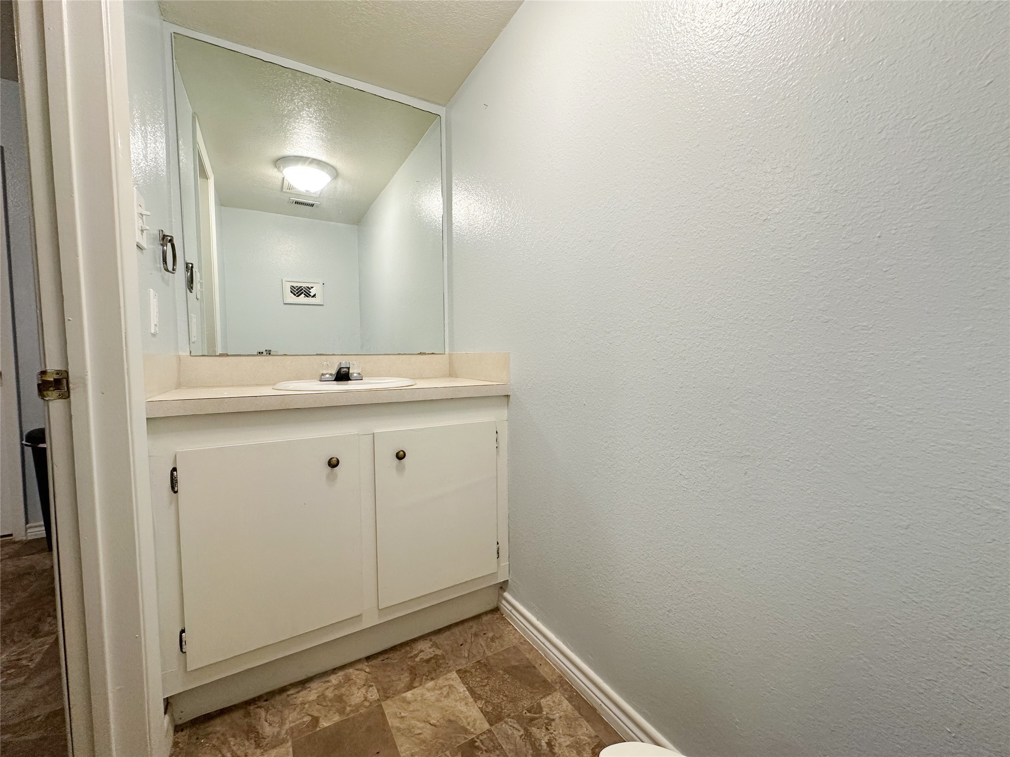 702 North Richmond Road Wharton, TX 77488 - Photo 15 of 24 a bathroom with a sink and a mirror