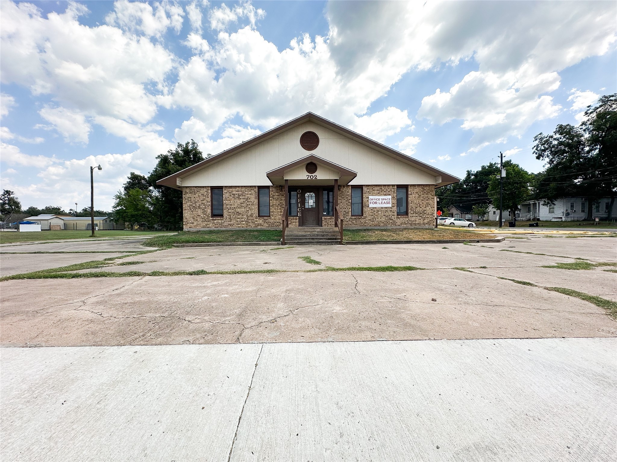 702 North Richmond Road Wharton, TX 77488 - Photo 2 of 24 a front view of a house with a yard