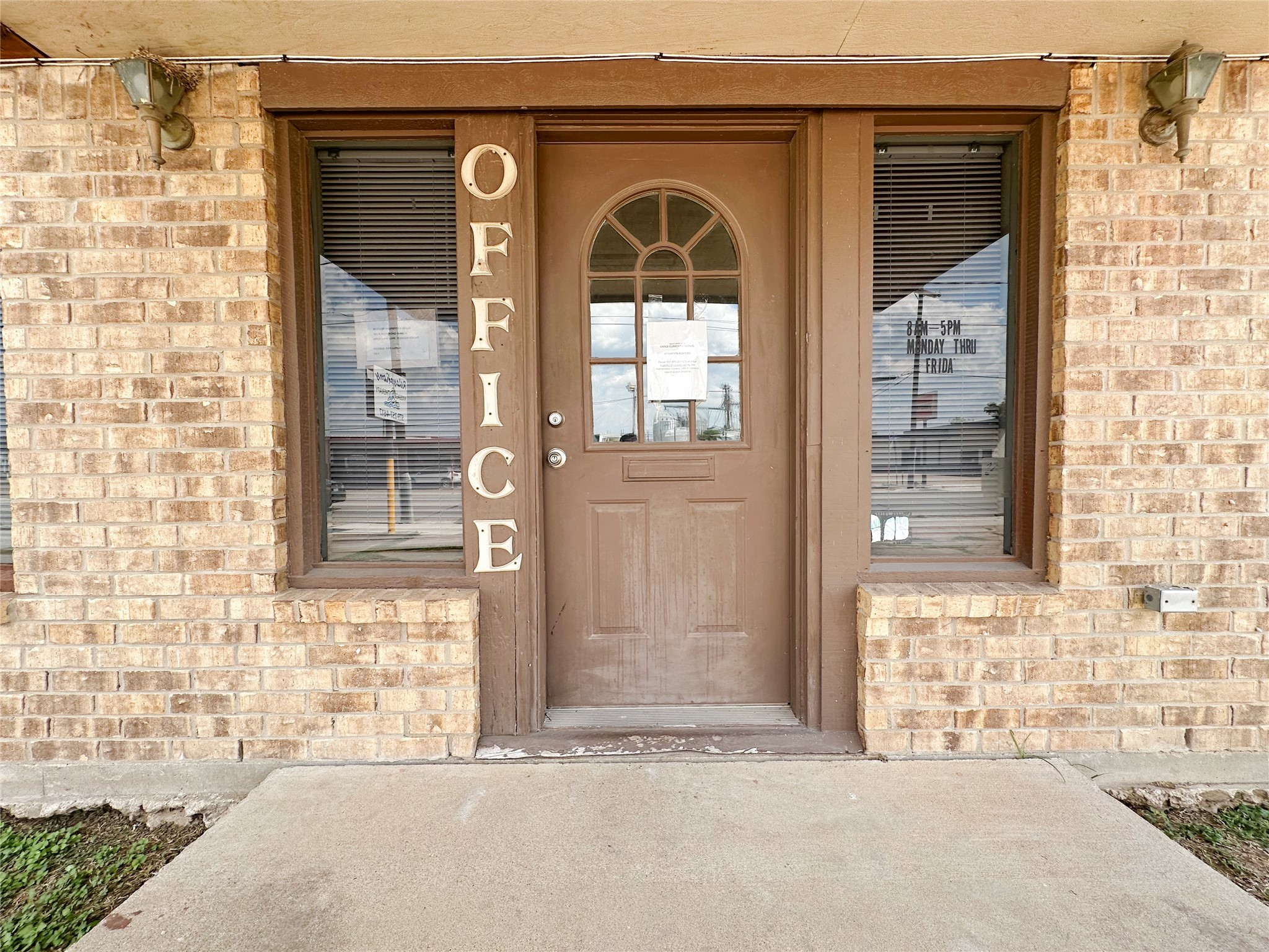 702 North Richmond Road Wharton, TX 77488 - Photo 4 of 24 a front view of a house with a glass door