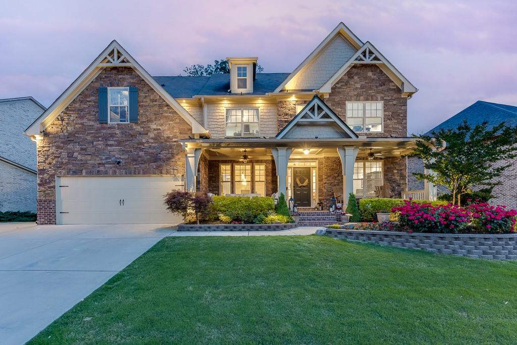 3939 Soft Wind Terrace Buford, GA 30518 - Photo 1 of 1 a front view of a house with a yard and potted plants