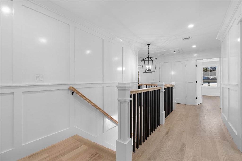 6 Sanders Lane Bolton, MA 01740 - Photo 17 of 36 a view of a hallway with wooden floor and kitchen