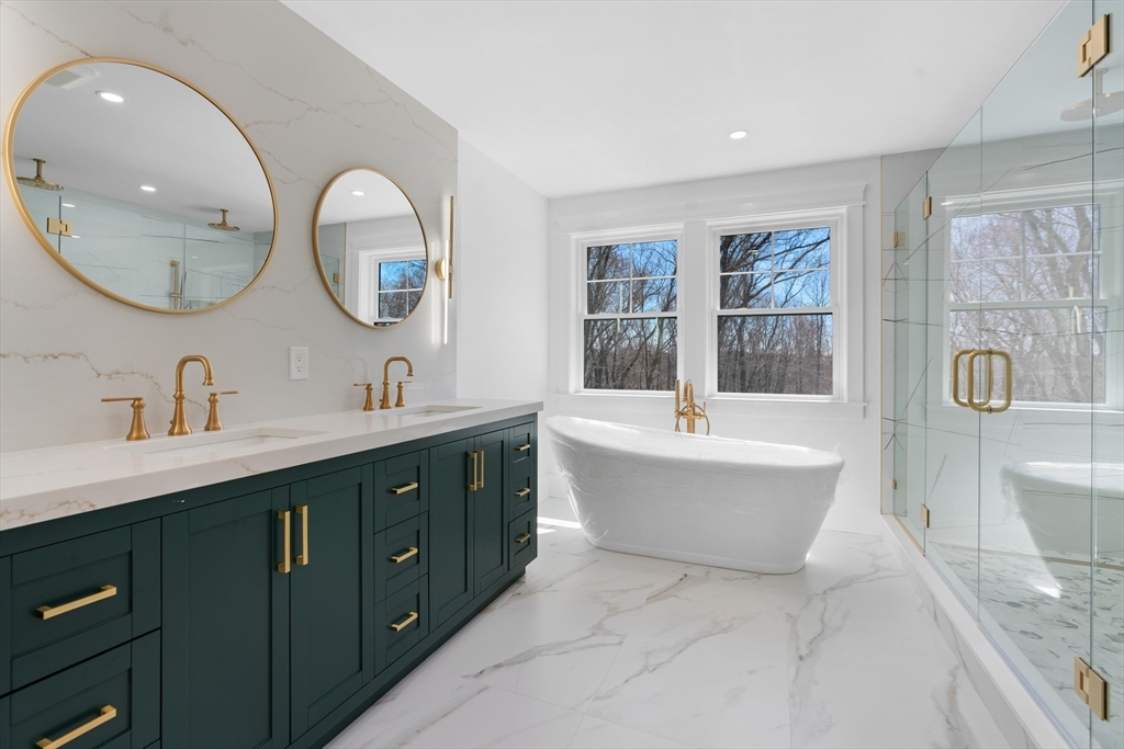 6 Sanders Lane Bolton, MA 01740 - Photo 18 of 36 a spacious bathroom with a double vanity sink a mirror and a bathtub