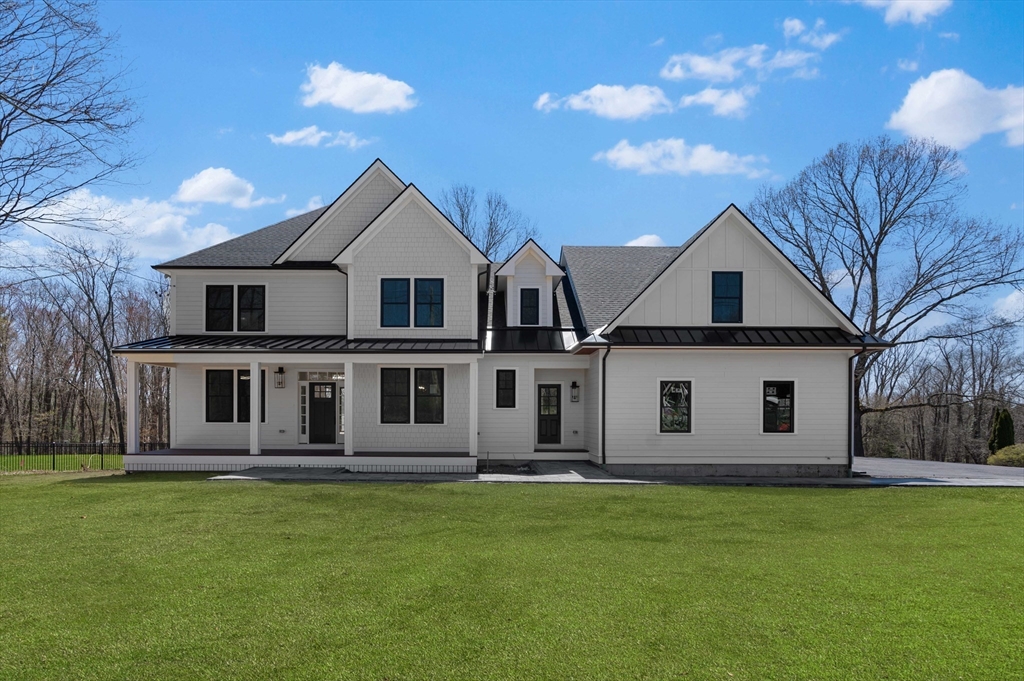 6 Sanders Lane Bolton, MA 01740 - Photo 2 of 36 a front view of a house with a garden