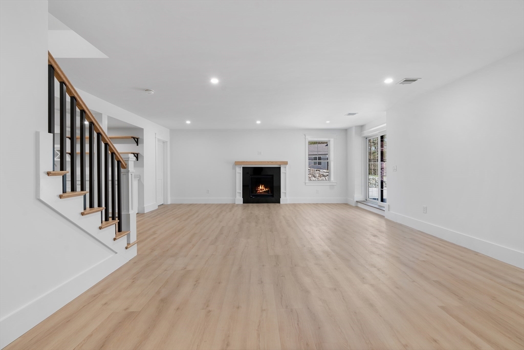 6 Sanders Lane Bolton, MA 01740 - Photo 30 of 36 an empty room with wooden floor and a ceiling fan