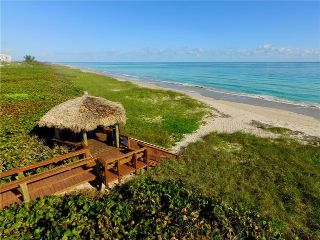 a view of a chairs and table in the balcony