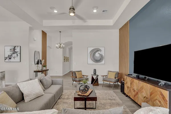 a kitchen with stainless steel appliances kitchen island granite countertop a sink a stove a refrigerator and chairs