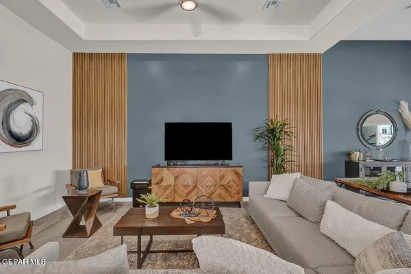 a living room with furniture a rug and a flat screen tv