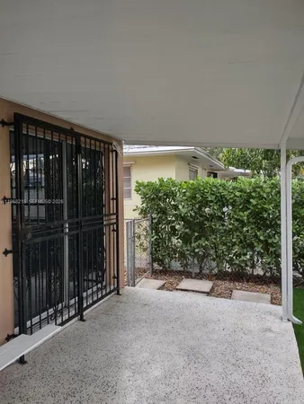 a view of a backyard with a tree