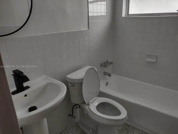 a bathroom with a sink a toilet and bathtub