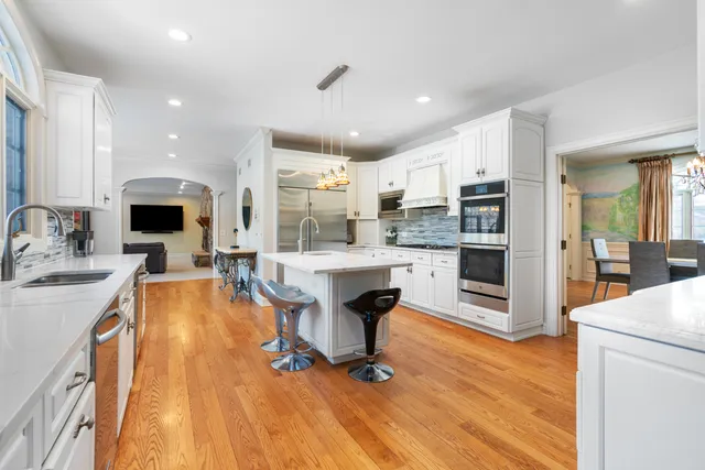 a living room with stainless steel appliances furniture a kitchen view and living room view