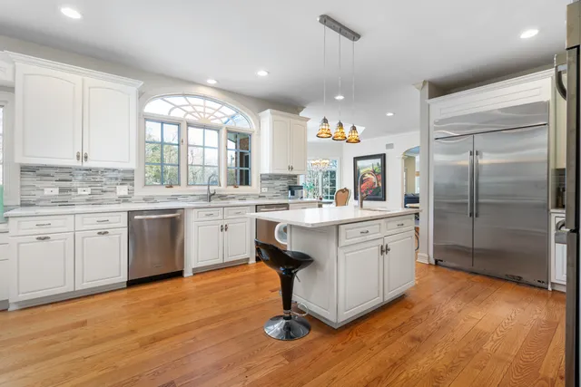a kitchen with a sink cabinets and wooden floor
