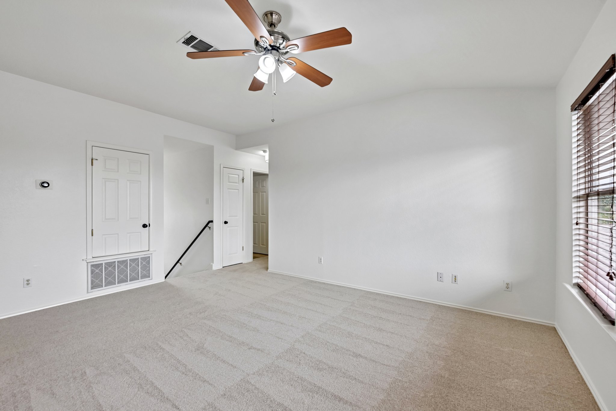 4100 Mocha Trail Austin, TX 78728 - Photo 12 of 33 A spacious room offers comfortable carpet flooring and a ceiling fan for year-round comfort.