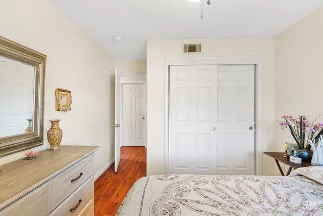 a bedroom with a bed and a potted plant