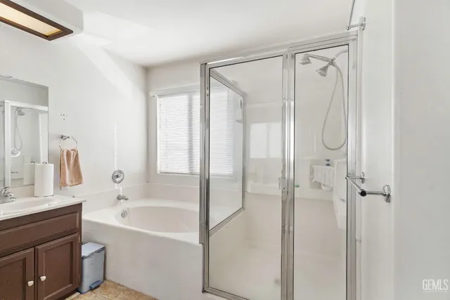 a bathroom with a bathtub shower sink and vanity