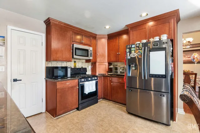 a kitchen with stainless steel appliances granite countertop a sink and a microwave
