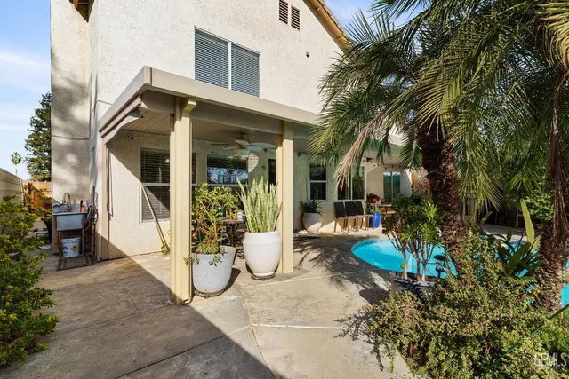 a view of a porch with chairs and backyard