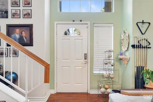a view of a hallway with wooden floor and entryway