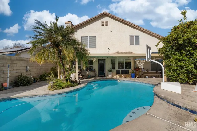 a front view of a house with swimming pool having outdoor seating