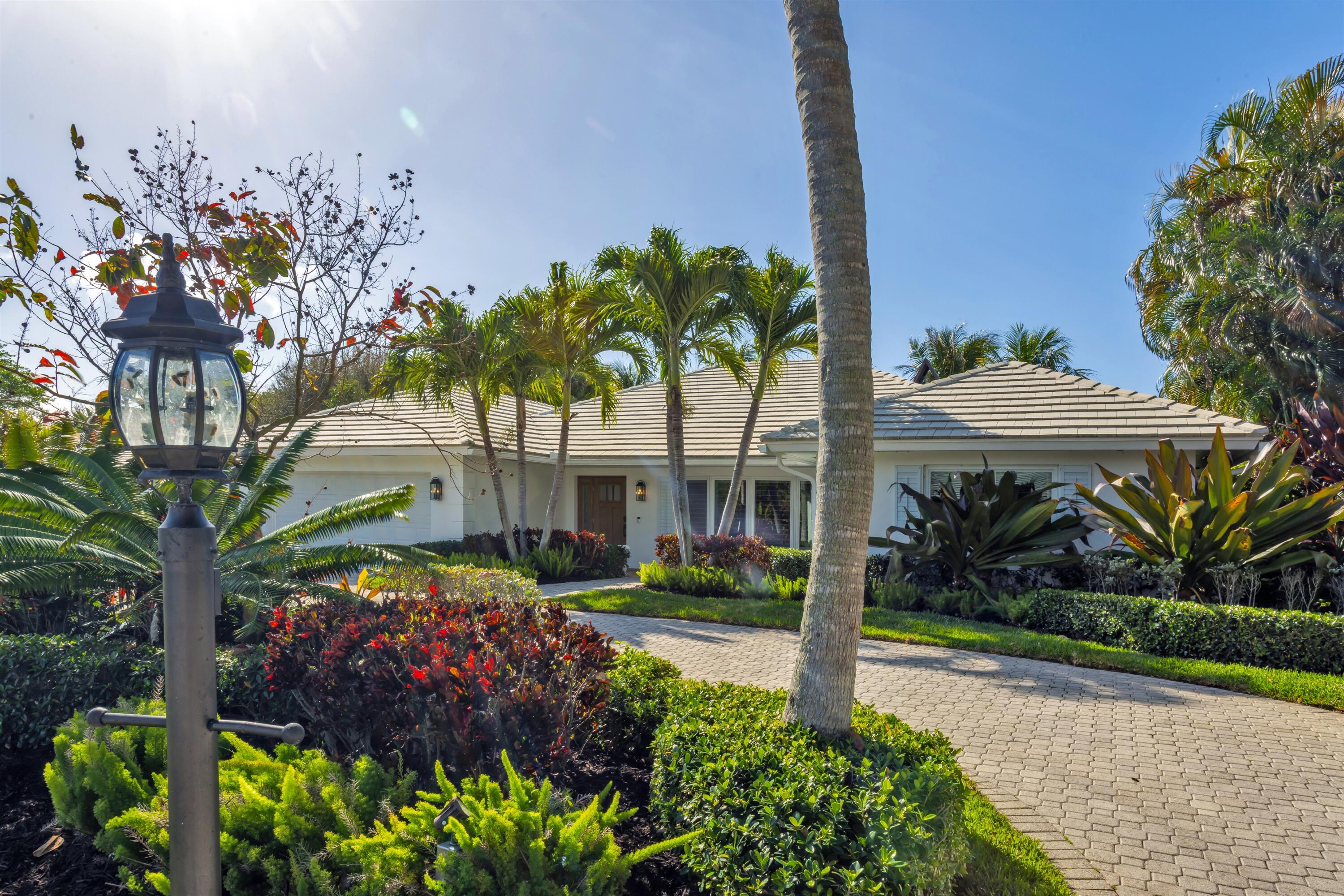 2720 Cardinal Circle Gulf Stream, FL 33483 - Photo 1 of 28 a front view of a house with a yard and fountain in middle