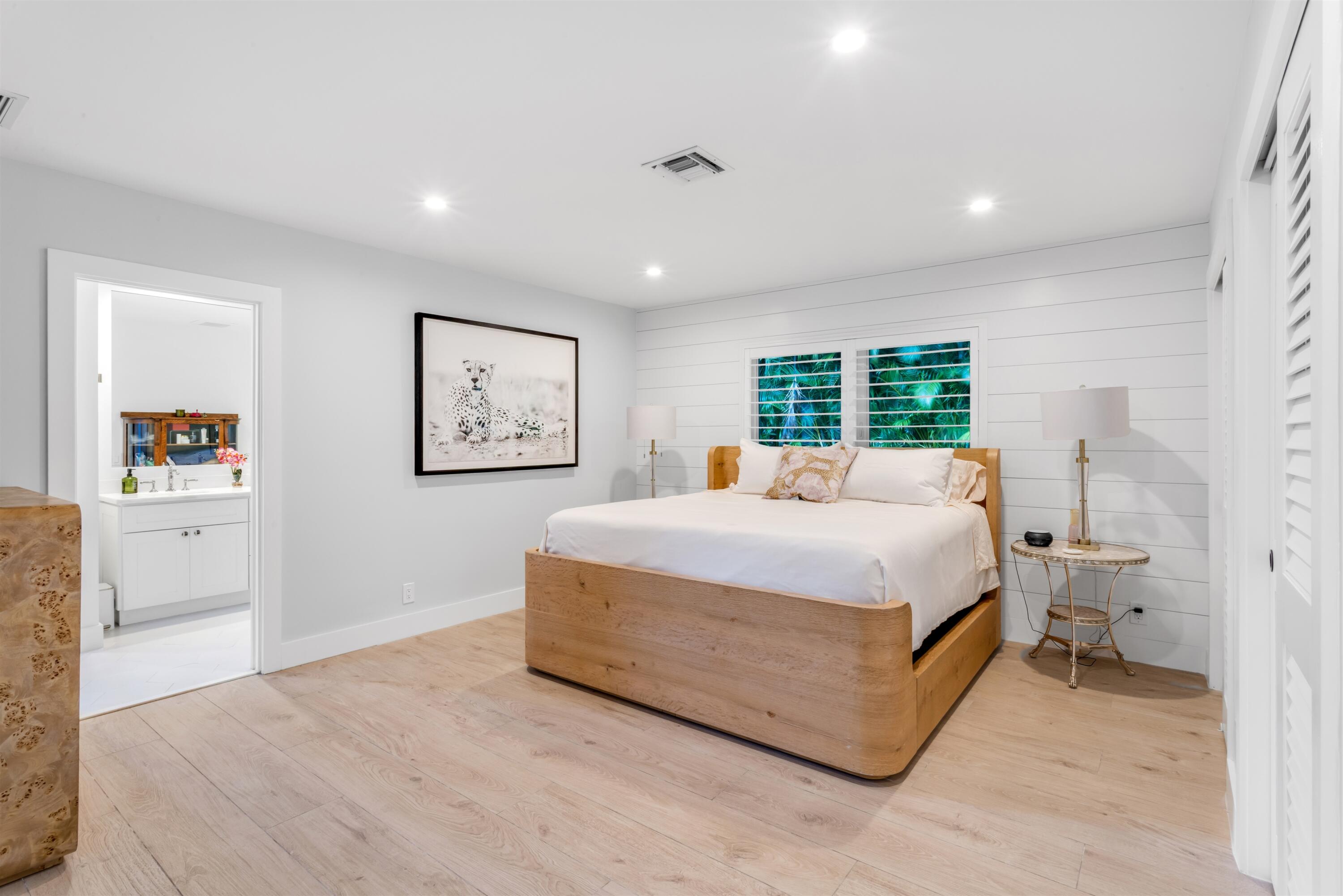 2720 Cardinal Circle Gulf Stream, FL 33483 - Photo 14 of 28 a bed room with a large bed and a large window