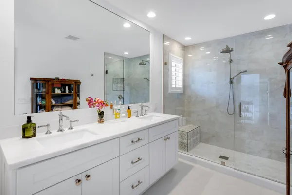 a bathroom with a shower sink and mirror