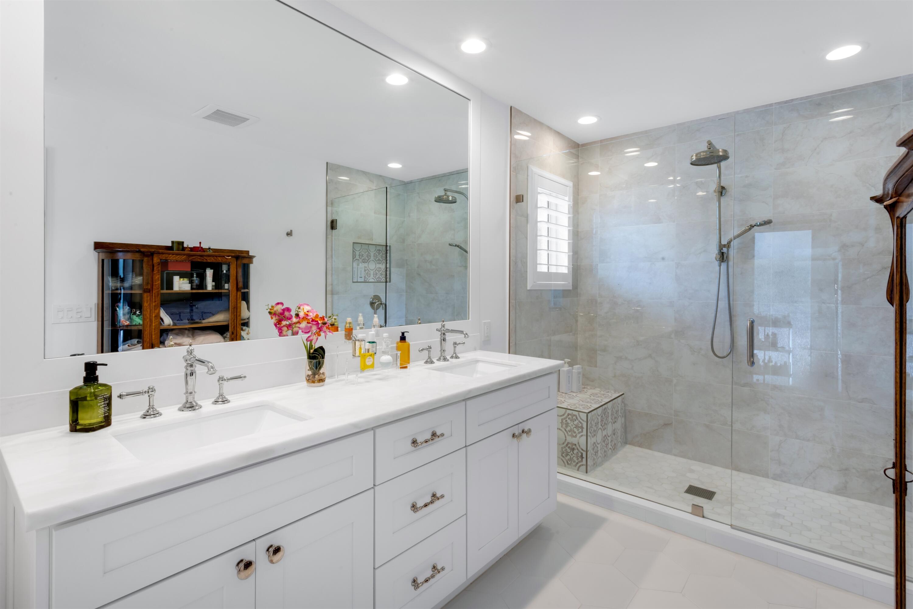 2720 Cardinal Circle Gulf Stream, FL 33483 - Photo 16 of 28 a bathroom with a shower sink and mirror
