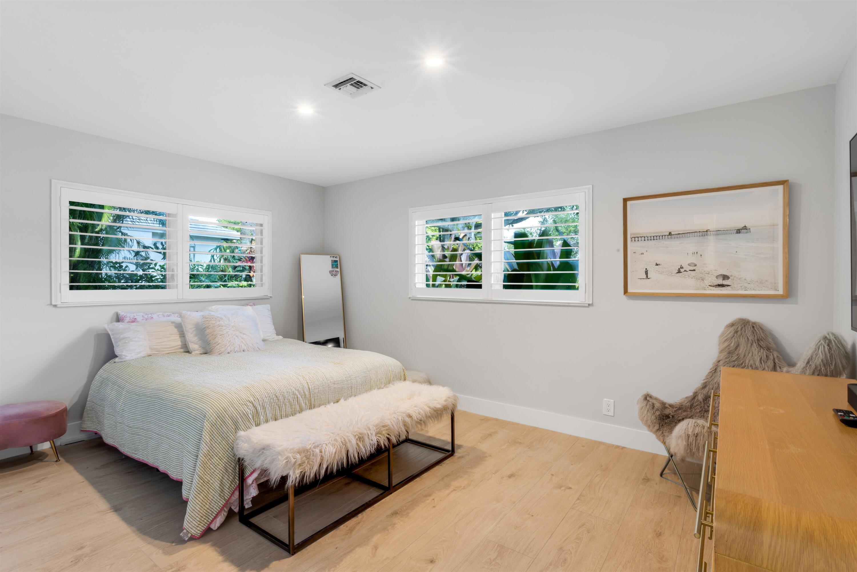 2720 Cardinal Circle Gulf Stream, FL 33483 - Photo 19 of 28 a bedroom with a bed and a painting on the wall
