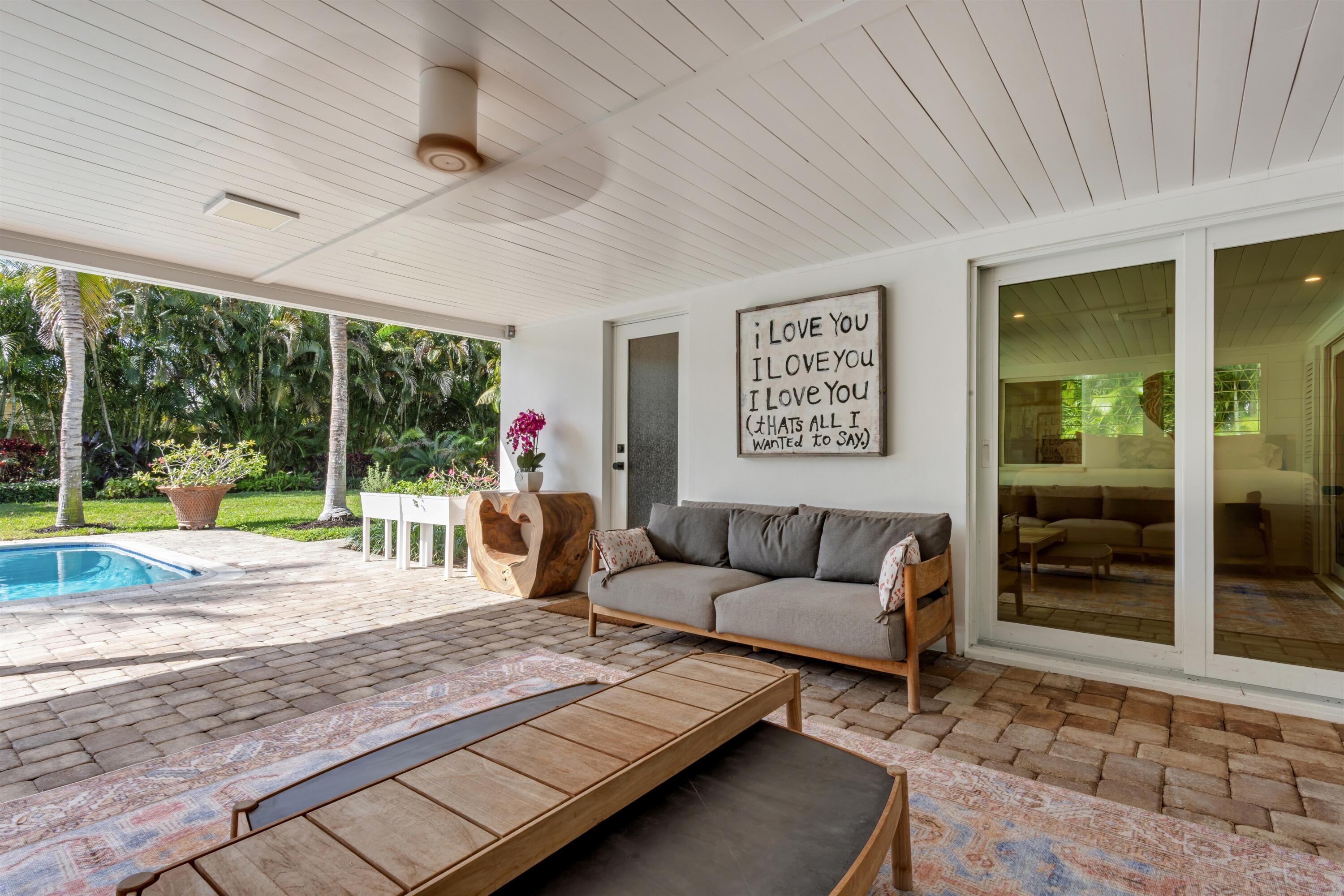 2720 Cardinal Circle Gulf Stream, FL 33483 - Photo 21 of 28 a living room with furniture and a floor to ceiling window