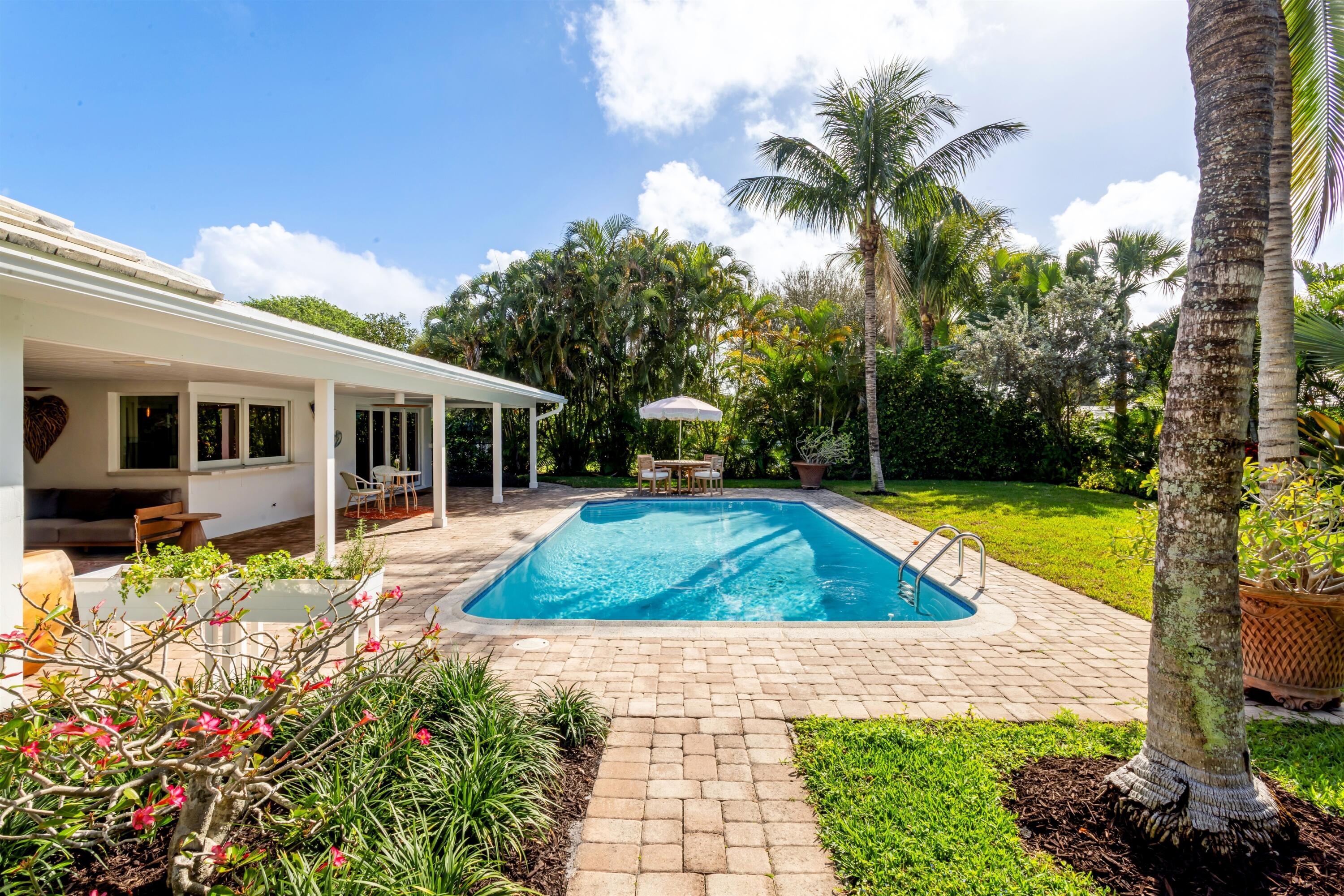 2720 Cardinal Circle Gulf Stream, FL 33483 - Photo 25 of 28 a view of a house with swimming pool and a yard