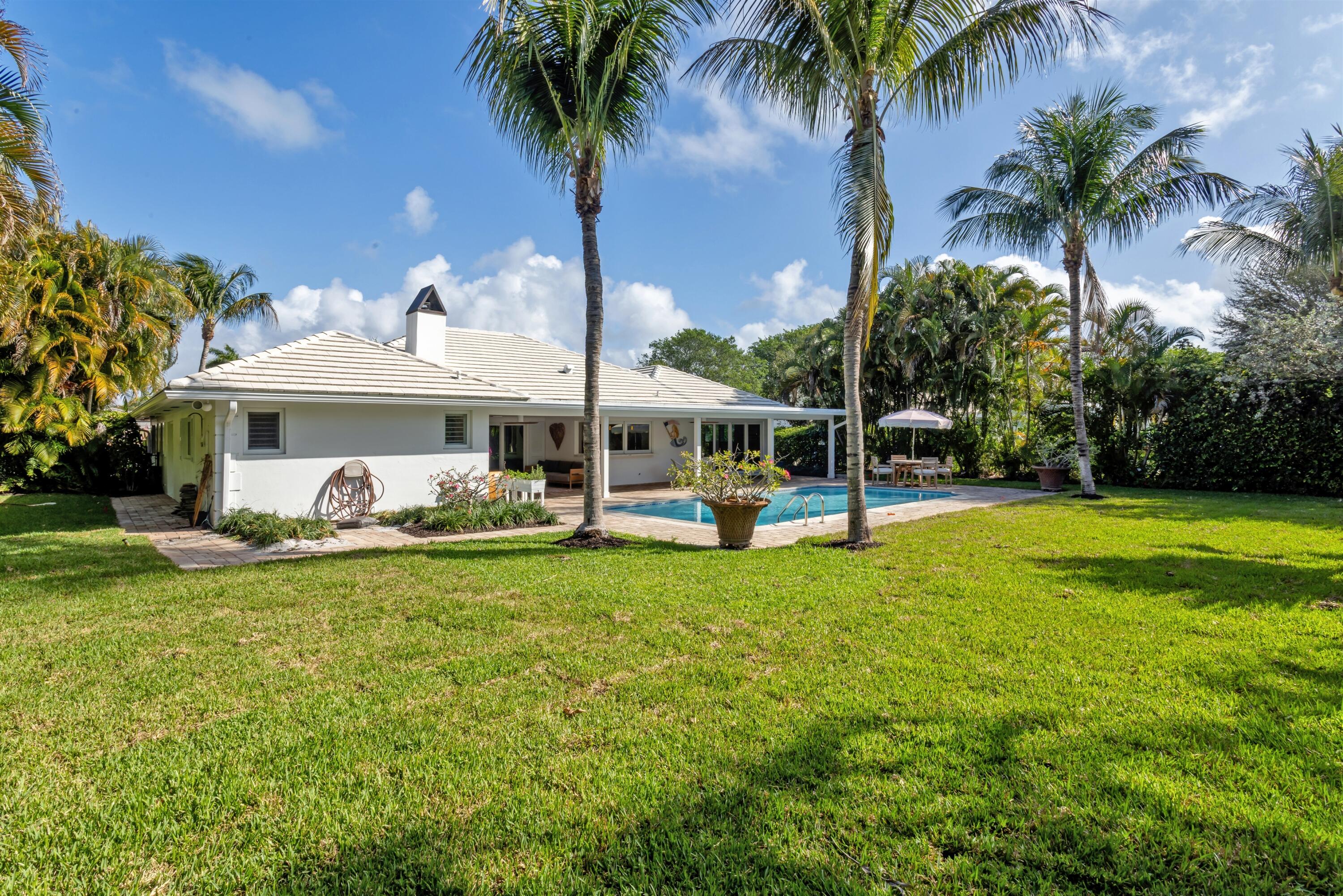 2720 Cardinal Circle Gulf Stream, FL 33483 - Photo 27 of 28 a front view of a house with swimming pool having outdoor seating