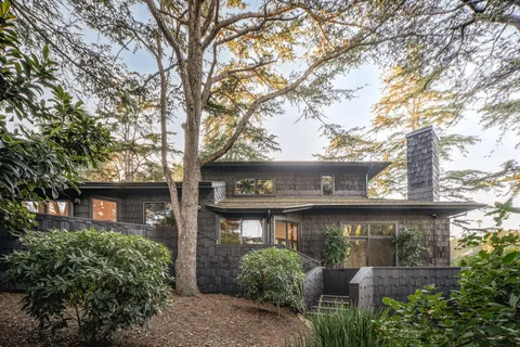 a view of a large house with large trees