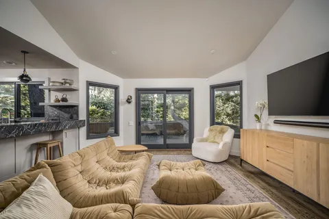 a work space with furniture a rug and a window