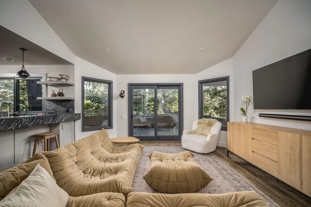 a work space with furniture a rug and a window