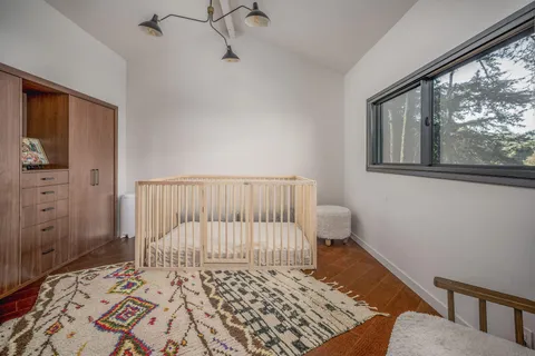 a bathroom with a granite countertop double vanity sink and mirror