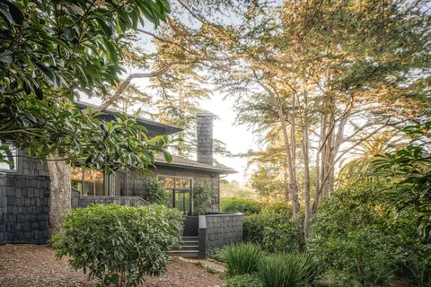 a front view of a house with garden