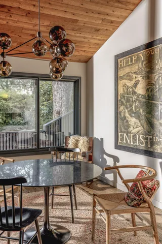 a dining room with furniture a chandelier and wooden floor